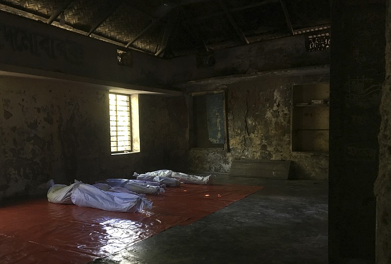 
              Bodies of Rohingya Muslim, who died after their boat capsized in the Bay of Bengal as they were crossing over from Myanmar into Bangladesh, lay on the local morgue in Shah Porir Dwip, Bangladesh's southern coastal district of Cox's Bazar, Monday, Oct. 9, 2017. (AP Photo/Rishabh Jain)
            