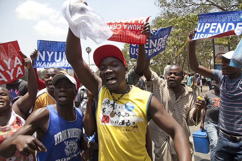 
              Opposition party supporters shout slogans as they hold posters which read "You like it or Not You have to Go" others read "Uhuru Bees are coming," as they march in Nairobi, Monday, Oct. 9, 2017. Thousands of supporters of Kenya's main opposition party, National Super Alliance (NASA) returned to the streets of Nairobi and other major towns Monday to protest against the Independent Electoral and Boundaries Commission (IEBC) ahead of Oct. 26 repeat presidential polls. (AP Photo/Sayyid Abdul Azim)
            