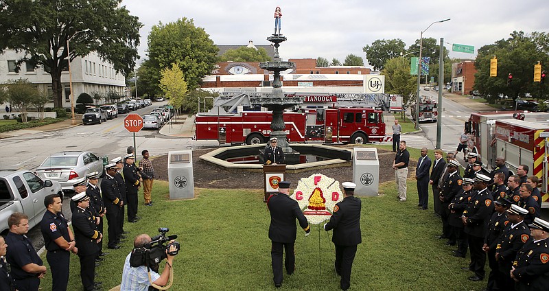 Assistant Fire Marshal Chuck Hartung, right, and Capt. David Thompson present a wreath honoring fallen firefighters during a ceremony at Fireman's Fountain, across from the Hamilton County Courthouse, on Monday, Oct. 9, in Chattanooga, Tenn. The ceremony kicked off Fire Prevention Week and included remarks from Mayor Andy Berke and Chattanooga Fire Marshal Beau Matlock.