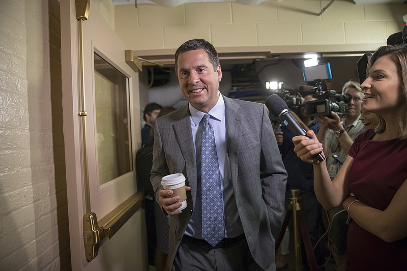 
              FILE - In this July 28, 2017, file photo, House Intelligence Committee Chairman Rep. Devin Nunes, R-Calif., walks on Capitol Hill in Washington. A political research firm behind a dossier of allegations about President Donald Trump's connections to Russia has been subpoenaed by the House intelligence committee. Joshua Levy, a lawyer for Fusion GPS, said in a statement Ton Oct. 10 that the subpoenas were signed by Nunes even though the Republican committee chairman stepped aside months ago from leading the panel's Russia probe. (AP Photo/J. Scott Applewhite, File)
            