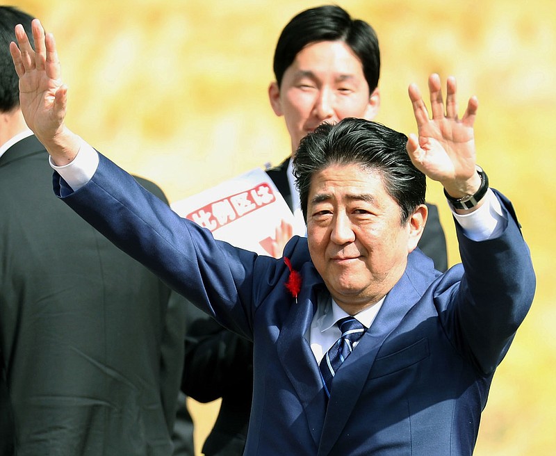 
              Japanese Prime Minister and leader of ruling Liberal Democratic Party Shinzo Abe waves to the crowd, during his party's election campaign in Fukushima, eastern Japan, Tuesday, Oct. 10, 2017. Hundreds of candidates have taken to the streets as a 12-day official campaigning for Japan’s Oct. 22 lower house election kicked off, with Prime Minister Abe’s ruling party facing challenges from regrouped opposition forces. (Takuya Inaba/Kyodo News via AP)
            