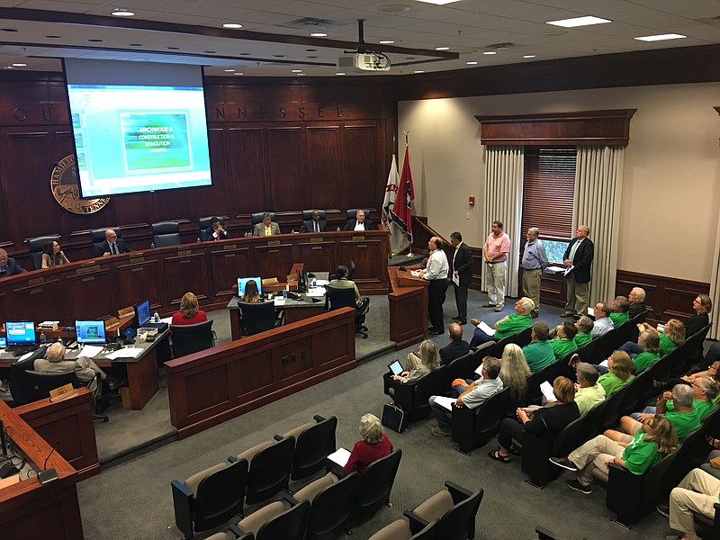 Greg Krum, president of landfill developer Birchwood II LLC, speaks to the Hamilton County Commission about a proposed construction and demolition landfill in Birchwood. Opponents of the new landfill, dressed in green "Keep Harrison Beautiful" T-shirts, fill seats immediately behind him.