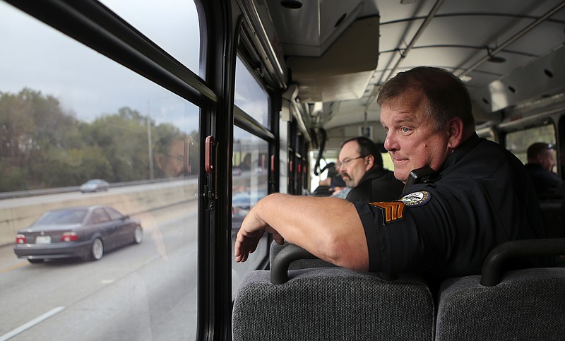 Chattanooga Police Department Sgt. Gary Martin monitors drivers from aboard the THP's bus on Wednesday, Oct. 11, in Chattanooga, Tenn. The bus, marked like THP cars, patrolled the highways around Chattanooga. Law enforcement officials aboard the bus monitored and reported distracted drivers and other offensives, such as not wearing seatbelts, to other officers on the road.