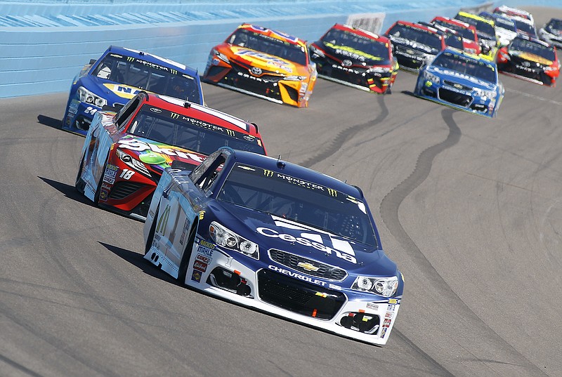 Jamie McMurray, front, drives through the first turn during a NASCAR Cup Series race at Phoenix International Raceway in March.
