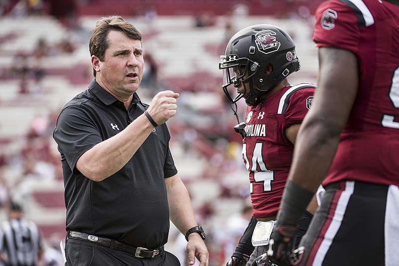 South Carolina football coach Will Muschamp, left, has led the Gamecocks to four wins in the first half of his second season leading the program. They travel to play Tennessee on Saturday.