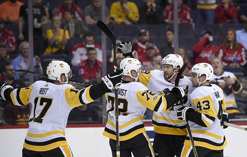 
              Pittsburgh Penguins defenseman Kris Letang (58) celebrates his goal with Conor Sheary (43), Patric Hornqvist (72) and Bryan Rust (17) during the first period of an NHL hockey game against the Washington Capitals, Wednesday, Oct. 11, 2017, in Washington. (AP Photo/Nick Wass)
            