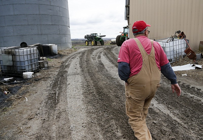 FILE - In this Tuesday, April 4, 2017, file photo, Blake Hurst, a corn and soybean farmer, walks to the tractor shed on his farm in Westboro, Mo. (AP Photo/Nati Harnik, File)