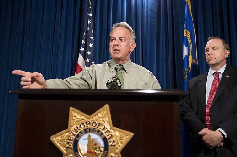 
              Clark County Sheriff Joe Lombardo, left, with Aaron C. Rouse, special agent in charge for the FBI in Nevada, discusses the Route 91 Harvest festival mass shooting at the Las Vegas Metropolitan Police Department headquarters in Las Vegas, Monday, Oct. 9, 2017. Law enforcement authorities on Monday made a significant change to the timeline of the mass shooting, saying the gunman shot a hotel security guard before he opened fire on concertgoers. (Erik Verduzco/Las Vegas Review-Journal via AP)
            