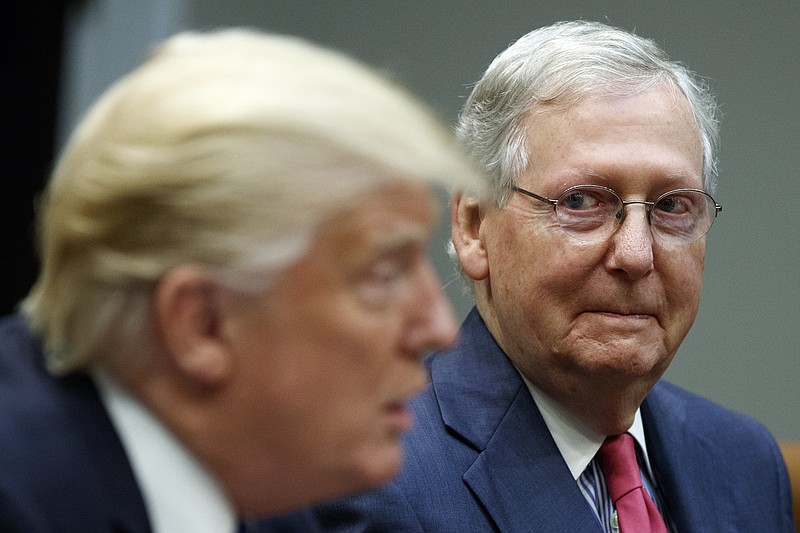 
              In this Sept. 5, 2017 photo, Senate Majority Leader Mitch McConnell, R-Ky., right, listens as President Donald Trump speaks during a meeting with Congressional leaders and administration officials in the Roosevelt Room of the White House in Washington. McConnell, facing increasing pressure from conservative groups, is promising to upend a longstanding Senate tradition in order to speed confirmations on a backlog of President Donald Trump's judicial nominees.  (AP Photo/Evan Vucci)
            