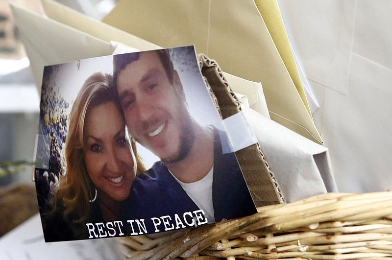 A photo of Scott Melton and his wife, Heather is seen taped to a basket of cards and letter before the funeral for Sonny Melton Tuesday, Oct. 10, 2017, in Big Sandy, Tenn. Melton, of Paris, Tenn., was one of the victims who died in the Oct. 1 mass shooting in Las Vegas. (AP Photo/Wade Payne)