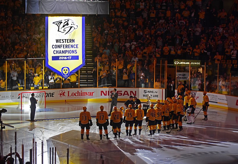 The Western Conference Championship banner is raised by the Nashville Predators before an NHL hockey game between the Predators and the Philadelphia Flyers Tuesday, Oct. 10, 2017, in Nashville, Tenn. (AP Photo/Mike Strasinger)