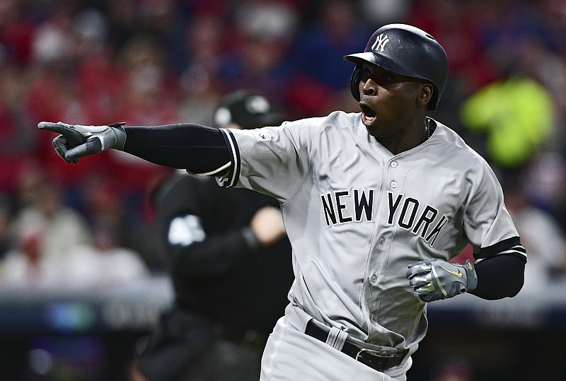 New York Yankees' Didi Gregorius points to the dugout after hitting a two-run home run off Cleveland Indians starting pitcher Corey Kluber during the third inning of Game 5 of a baseball American League Division Series, Wednesday, Oct. 11, 2017, in Cleveland. (AP Photo/David Dermer)