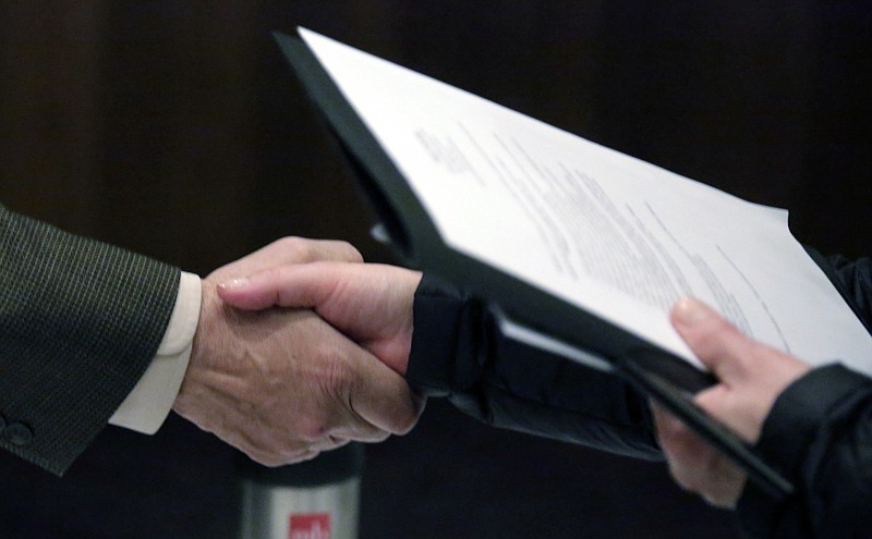 
              FILE - In this April 22, 2015, file photo, a recruiter, left, shakes hands with a job seeker during a National Career Fairs job fair in Chicago. On Thursday, Oct. 12, 2017, the U.S. Labor Department reports on the number of people who applied for unemployment benefits the week before. (AP Photo/M. Spencer Green, File)
            