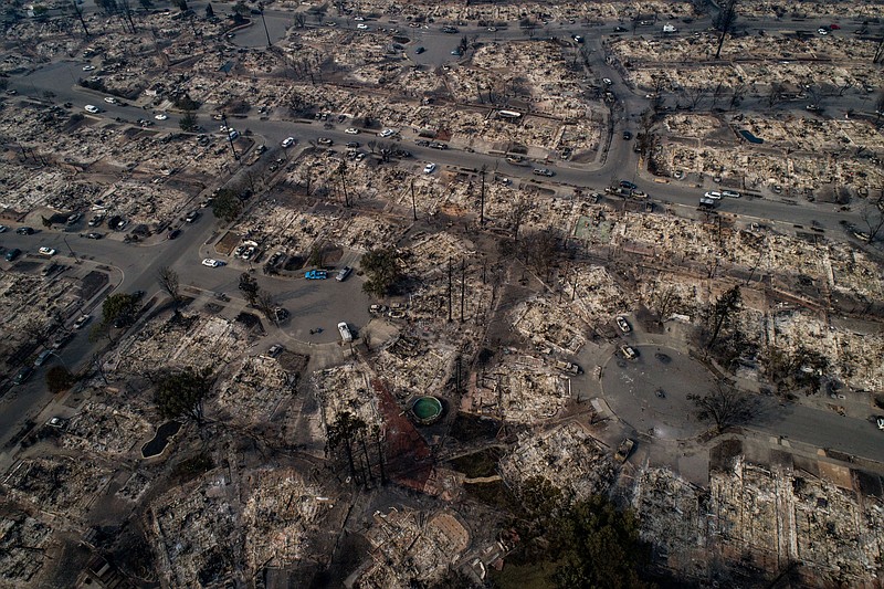 An aerial view of homes burned by wildfire in the Coffey Park neighborhood of Santa Rosa, Calif., on Tuesday. Fires which began just two days prior had burned about 115,000 acres over eight counties in California's wine country; at least 17 people are dead and some 2,000 structures are damaged or destroyed. (Josh Haner/The New York Times)