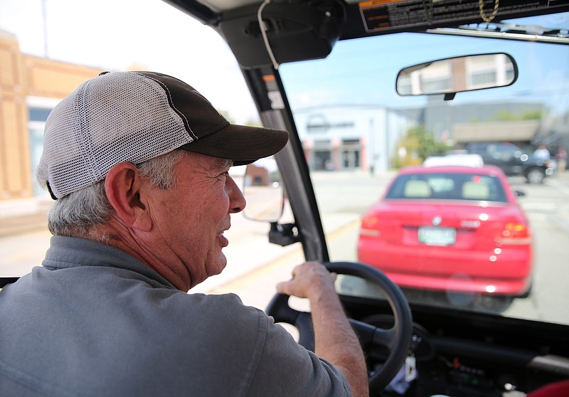 Joe "Dixie" Fuller drives his street-legal golf cart around downtown Chattanooga. Fuller says he and his wife, Shannon, are much more likely to do stuff outside of their home since getting around and parking their golf cart makes dealing with traffic much easier.