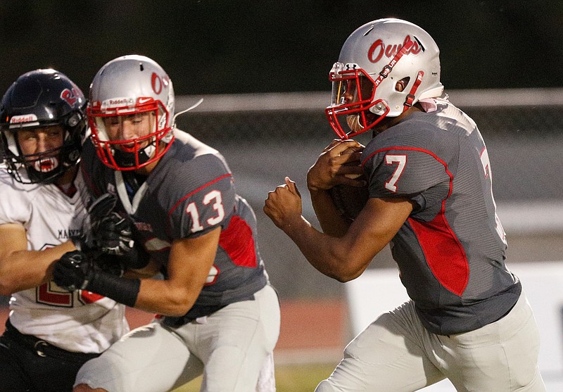 Ooltewah defensive back Andrew Manning (13) blocks Maryville defensive back Noah Humphreys, left, as Ooltewah quarterback Kyrell Sanford runs in a touchdown during their prep football game against Maryville at Ooltewah High School on Thursday, Oct. 12, 2017, in Ooltewah, Tenn.