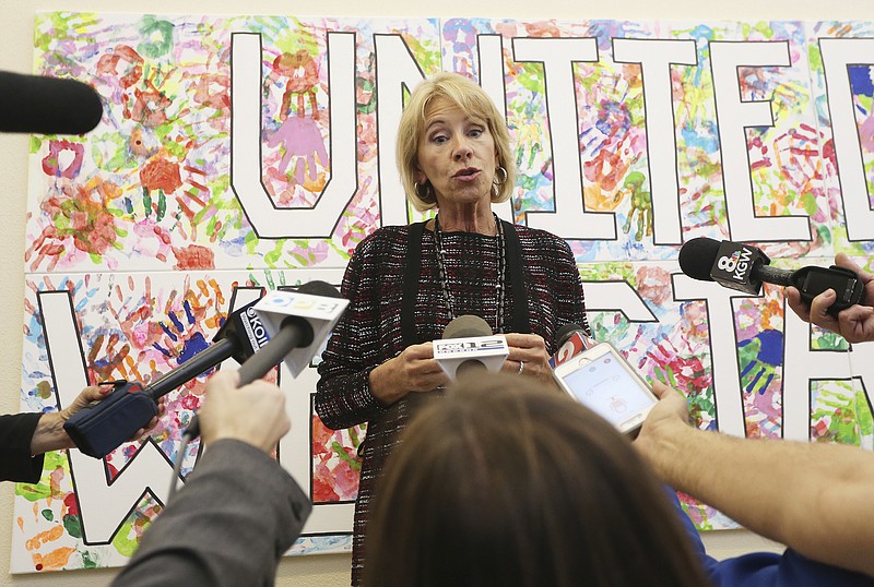 
              Education secretary Betsy DeVos addresses reporters during her visit to McMinnville High School in McMinnville, Ore., Wednesday, Oct. 11, 2017. (Rockne Roll/News Register via AP)
            