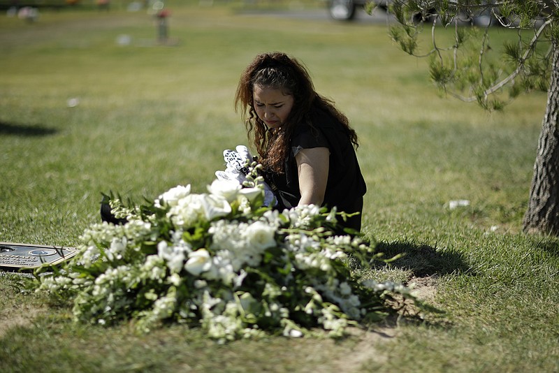 
              Chantel Sosa cries at the graveside during a funeral for her brother Erick Silva, Thursday, Oct. 12, 2017, in Las Vegas. Silva was working as a security guard when he was killed during a mass shooting Oct. 1, in Las Vegas. (AP Photo/John Locher)
            