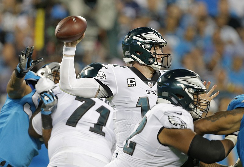 
              Philadelphia Eagles' Carson Wentz (11) looks to pass against the Carolina Panthers in the second half of an NFL football game in Charlotte, N.C., Thursday, Oct. 12, 2017. (AP Photo/Bob Leverone)
            