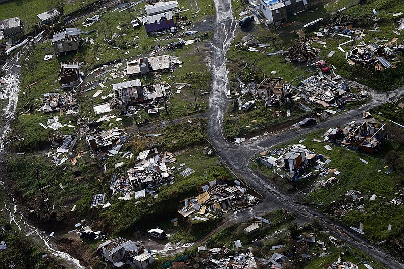 In this Thursday, Sept. 28, 2017 file photo, destroyed communities are seen in the aftermath of Hurricane Maria in Toa Alta, Puerto Rico. The House is on track to backing President Donald Trump's request for billions more in disaster aid, $16 billion to pay flood insurance claims and emergency funding to help the cash-strapped government of Puerto Rico stay afloat. The hurricane aid package Thursday, Oct. 12, 2017, totals $36.5 billion and sticks close to a White House request, ignoring - for now - huge demands from the powerful Florida and Texas delegations, who together pressed for some $40 billion more. (AP Photo/Gerald Herbert, File)