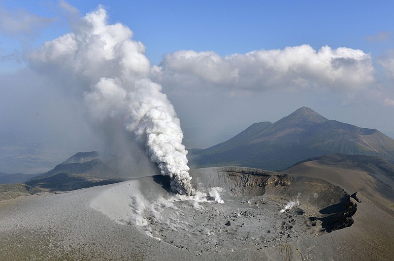 
              Volcanic smoke rises from the Shinmoedake volcano after its eruption in the border of Kagoshima and Miyazaki prefectures, southwestern Japan, Thursday, Oct. 12, 2017. The volcano erupted Thursday for the first time in six years and spread ash in nearby cities and towns. (Tomoaki Ito/Kyodo News via AP)
            