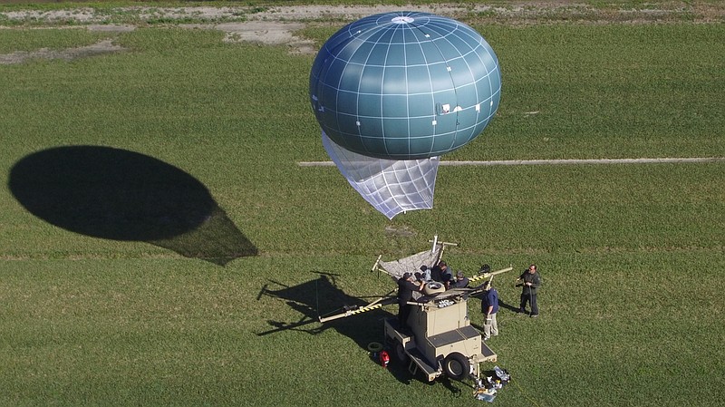 
              In this undated aerial photo provided by Drone Aviation Corp. shows a tethered balloon, called Winch Aerostat Small Platform, or WASP.  The U.S. Border Patrol is considering another type of surveillance balloon to spot illegal activity. It’s part of an effort to see if more eyes in the sky translate to fewer illegal border crossings.  (Drone Aviation Corp. via AP)
            