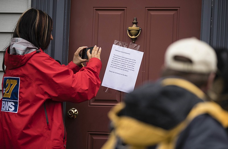 
              Members of the media make images of a posted note on the front door of Jim and Lyn Coleman's home in Stewartstown, Pa., Thursday, Oct. 12, 2017. The Coleman's daughter Caitlan Coleman, her Canadian husband and their three young children have been released after years held captive by a group that has ties to the Taliban and is considered a terrorist organization by the United States, U.S. and Pakistani officials said Thursday. (AP Photo/Matt Rourke)
            