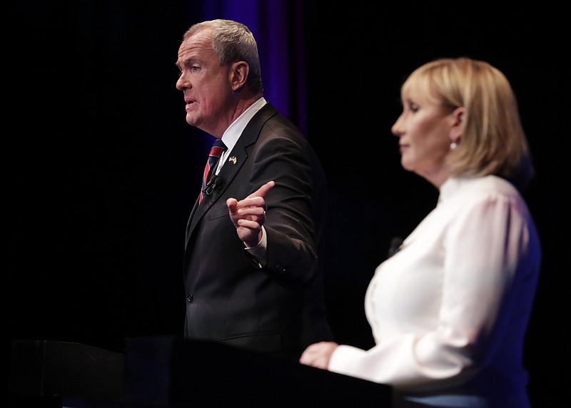 
              Democratic nominee Phil Murphy, left, answers a question as Republican nominee Lt. Gov. Kim Guadagno, right, listens during a gubernatorial debate at the New Jersey Performing Arts Center, Tuesday, Oct. 10, 2017, in Newark, N.J. (AP Photo/Julio Cortez, Pool)
            