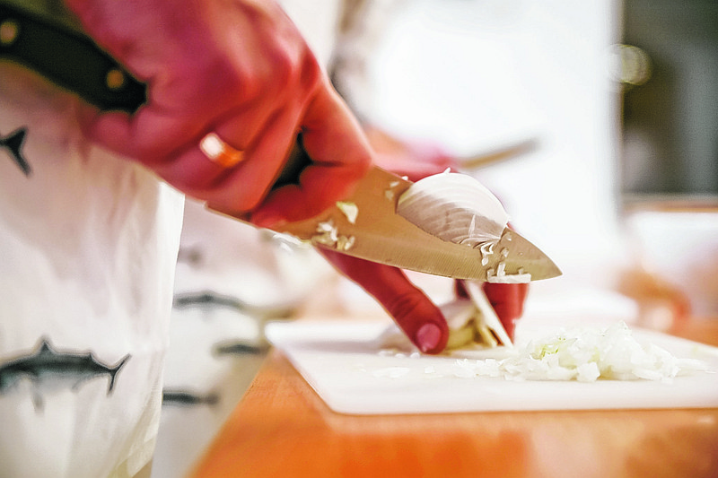 Cooking classes instructor showing how to cut an onion. (Contributed photo)