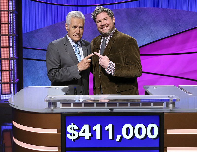 
              CORRECTS LAST NAME TO TREBEK INSTEAD OF TREBEC  This image released by Jeopardy Productions, Inc. shows "Jeopardy!" host Alex Trebek, left, and contestant Austin Rogers, whose 12-game winning streak came to an end on Thursday's broadcast. Rogers finished his run in fifth place on the all-time regular-season (non-tournament), winning $411,000. (Carol Kaelson/Jeopardy Productions, Inc. via AP)
            