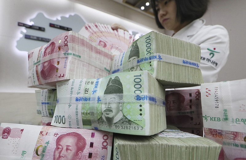 
              Bundles of South Korean and Chinese banknotes are displayed at the headquarters of KEB Hana Bank in Seoul, South Korea, Friday, Oct. 13, 2017. South Korea and China agreed to extend their currency swap deal, Seoul said Friday, easing concerns the deal would fall through due to tensions over a U.S. missile defense system. (Lee Ji-eun/Yonhap via AP)
            