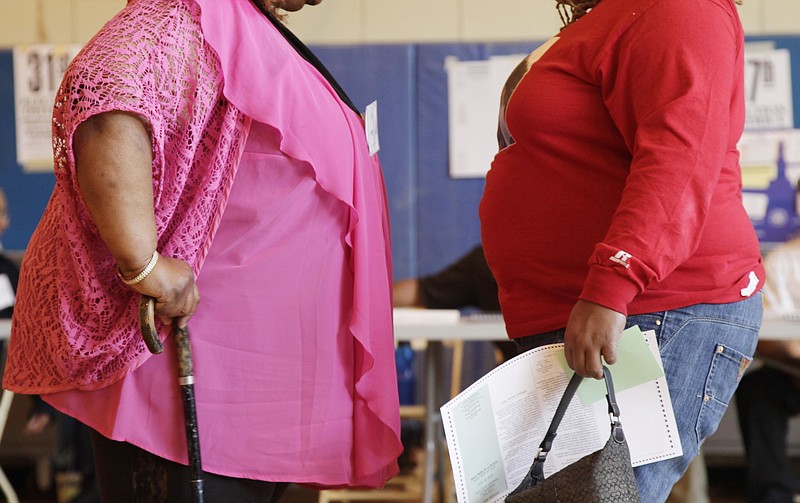 
              FILE - In this June 26, 2012 file photo, two women converse in New York. New government figures released Friday, Oct. 13, 2017 showed small increases that were not considered statistically significant but were seen by some as a cause for concern. The adult obesity rate rose from to about 40 percent, from just shy of 38 percent. (AP Photo/Mark Lennihan)
            