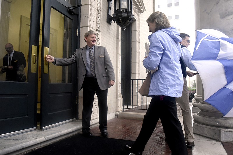 Deacon Walt Goldston greets church members as he opens the door to the main entrance of the church along McCallie Ave.  First Presbyterian's deacons serve as greeters and are considered part of the security team.  In the wake of shootings at places of worship churches such as First Presbyterian has have deployed security personal to protect their members.  First Presbyterian's security details were photographed on October 8, 2017.