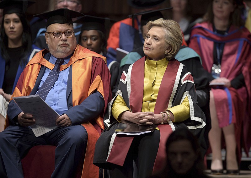 
              US politician Hillary Rodham Clinton, right, sits in the Great Hall at Swansea University, prior to receiving an Honorary Doctorate in recognition of her commitment to promoting the rights of families and children around the world, in Swansea, Wales, Saturday, Oct. 14, 2017. (Ben Birchall/PA via AP)
            