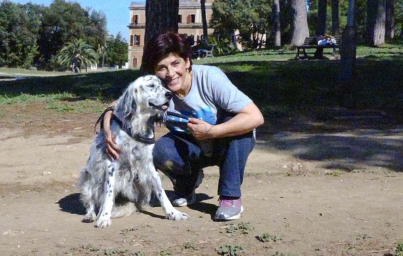 
              This undated photo made available Thursday, Oct. 12, 2017, shows an Italian librarian (name not available) who has won the right from her employer to use family sick leave to care for her ailing pet instead of having to use vacation days, posing with her dog Cucciola in a park in Rome. The woman said the dog is recovering well from surgery for a breast tumor and a larynx problem. The woman, who is single and has no family help for Cucciola, declined to be identified. (Str/ANSA via AP)
            