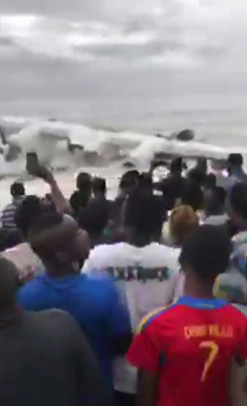
              A crowd gathers at the shoreline after a cargo plane crashed Saturday into the Atlantic Ocean shortly after taking off from Ivory Coast's international airport in Abidjan, Ivory Coast, Saturday Oct. 14, 2017.  The plane is believed to be carrying French military cargo, and eyewitnesses report seeing four dead among the wreckage. (Ange Koutaye Ismael via AP)
            