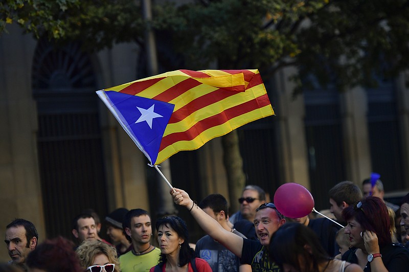 
              A pro independence supporter holds up an ''estelada'' or Catalan pro independence flag during a rally in support of the Catalonia's secession from Spain, in Pamplona, northern Spain, Thursday, Oct. 12, 2017. Spain's celebrates its national day amid one of the country's biggest crises ever as its powerful northeastern region of Catalonia threatens independence.(AP Photo/Alvaro Barrientos)
            