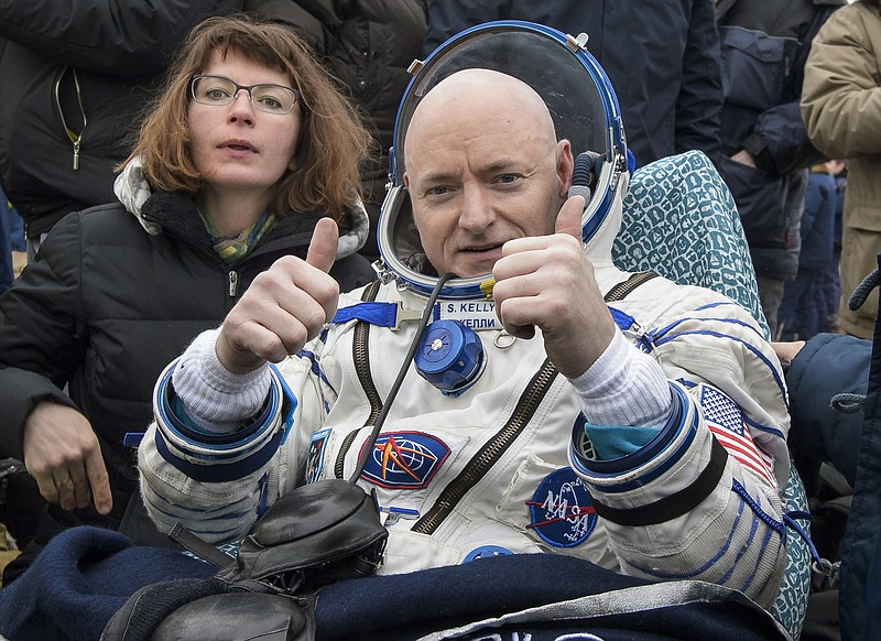 In this Wednesday, March 2, 2016 photo provided by NASA, International Space Station (ISS) crew member Scott Kelly of the U.S. reacts after landing near the town of Dzhezkazgan, Kazakhstan. In his new autobiography, the retired astronaut writes about his U.S. record-breaking year in space and the challenging life events that got him there. (Bill Ingalls/NASA via AP)