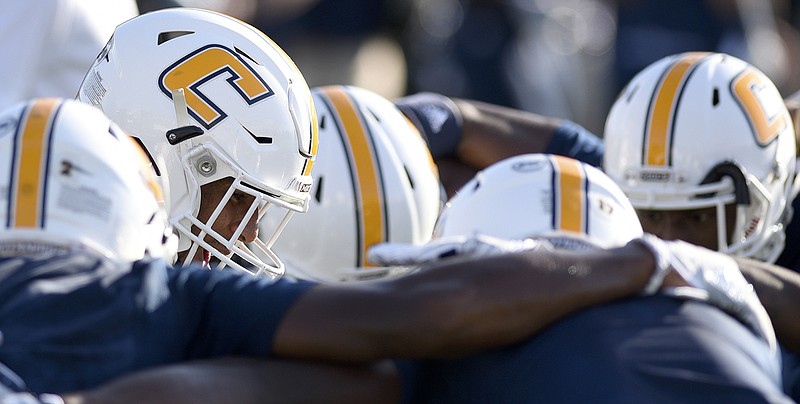 UTC safety Lucas Webb, left, huddles with his teammates before a game against Western Carolina last month at Finley Stadium.