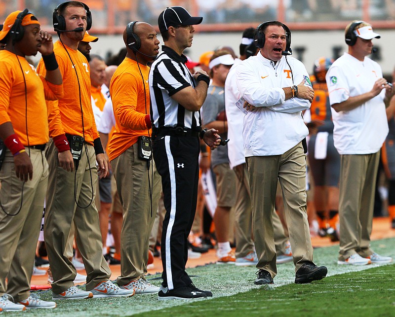 Tennessee football coach Butch Jones, right of official, is 33-24 with the Vols midway through his fifth season in Knoxville. He has led the program to three straight bowl wins but no SEC East championships.