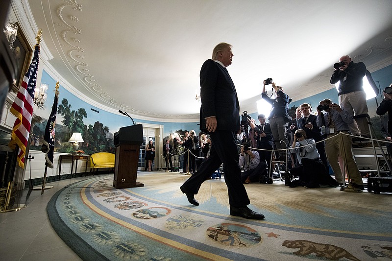 President Donald Trump exits after announcing that he will not certify Iran's compliance with the nuclear deal that was negotiated by his predecessor, Barack Obama. Trump spoke in the Diplomatic Reception Room of the White House, in Washington on Friday. (Doug Mills/The New York Times)