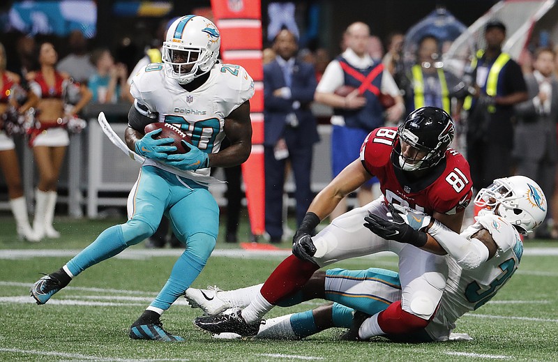 
              Miami Dolphins free safety Reshad Jones (20) picks up the ball against Atlanta Falcons tight end Austin Hooper (81) during the second half of an NFL football game, Sunday, Oct. 15, 2017, in Atlanta. The Miami Dolphins won 20-17. (AP Photo/David Goldman)
            