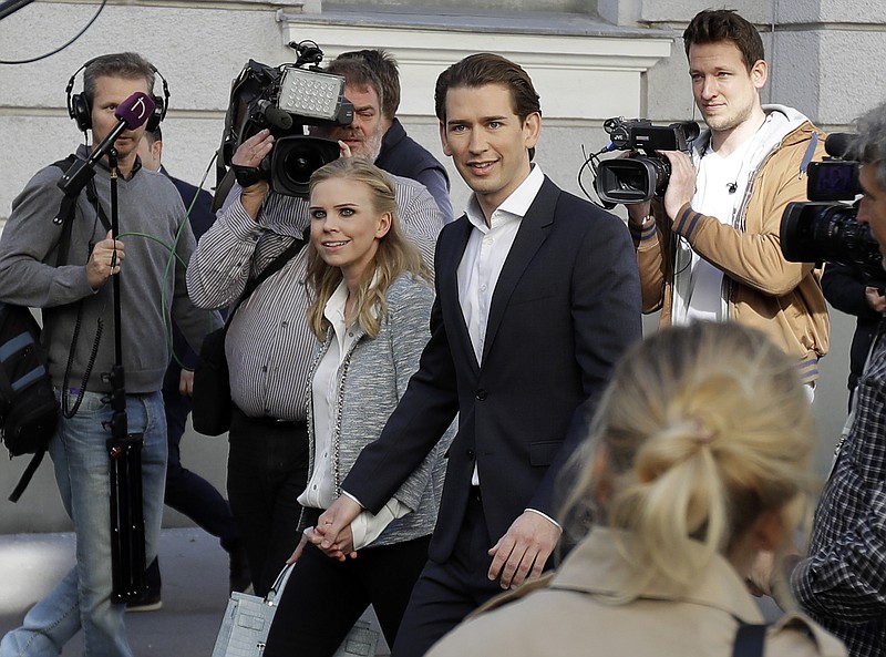 
              Foreign Minister Sebastian Kurz, head of Austrian People's Party, and his girlfriend Susanne Thier arrive to the polling station to casts their vote in Vienna, Austria, Sunday, Oct. 15, 2017, when about 6.4 million people are eligible to vote in the national elections. (AP Photo/Matthias Schrader)
            