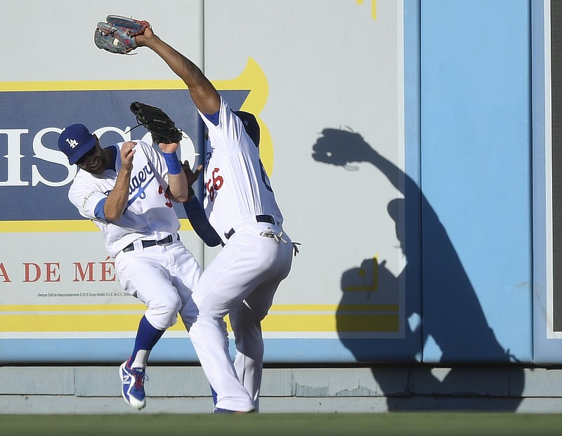 
              Los Angeles Dodgers right fielder Yasiel Puig, right, catches a fly ball hit by Chicago Cubs' Kris Bryant over the top of center fielder Chris Taylor during the first inning of Game 2 of baseball's National League Championship Series in Los Angeles, Sunday, Oct. 15, 2017. (AP Photo/Mark J. Terrill)
            