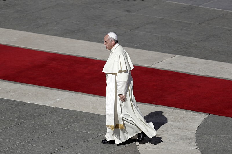 
              Pope Francis leaves at the end of a canonization mass in St. Peter's Square at the Vatican, Sunday, Oct.15, 2017. The pontiff canonized thirty martyrs, including priests and lay persons, suffered anti-Catholic persecution in 1645 at the hands of Dutch Calvinists in Brazil, while three children, indigenous persons in 16th-century Mexico, were martyred for embracing the Catholic faith and refusing to return to their ancient conditions. The other two new saints are a 20th-century priest from Spain and an Italian priest who died in 1739. (AP Photo/Andrew Medichini)
            