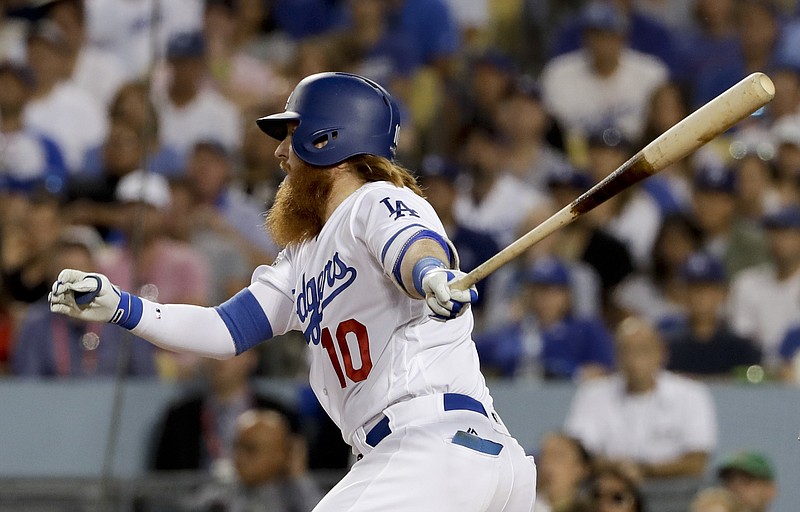 Los Angeles Dodgers' Justin Turner watches his RBI-single against the Chicago Cubs during the fifth inning of Game 2 of baseball's National League Championship Series in Los Angeles, Sunday, Oct. 15, 2017. (AP Photo/Matt Slocum)