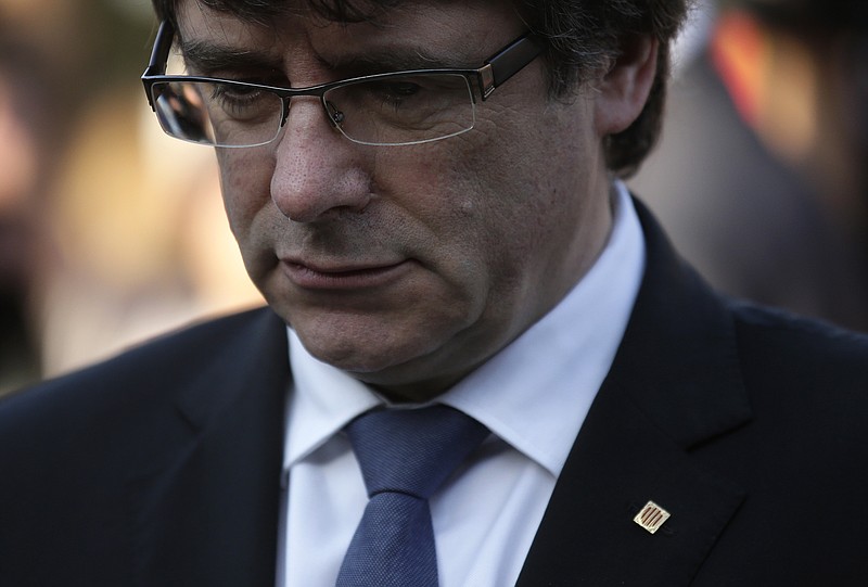 
              Catalan regional President Carles Puigdemont attends a ceremony commemorating the 77th anniversary of the death of Catalan leader Lluis Companys at the Montjuic Cemetery in Barcelona, Spain, Sunday, Oct. 15, 2017. Catalonia's president is facing a critical decision that could determine the course of the region's secessionist movement to break away from Spain. (AP Photo/Manu Fernandez)
            