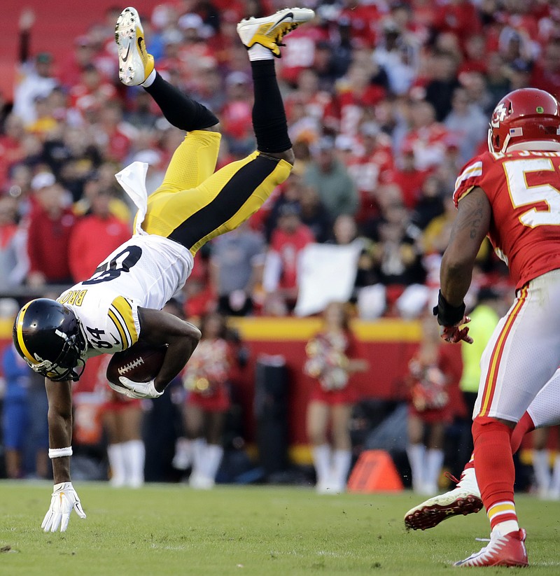 
              Kansas City Chiefs linebacker Derrick Johnson, right, watches as Pittsburgh Steelers wide receiver Antonio Brown (84) is flipped by a tackle by Chiefs linebacker Kevin Pierre-Louis during the second half of an NFL football game in Kansas City, Mo., Sunday, Oct. 15, 2017. (AP Photo/Charlie Riedel)
            