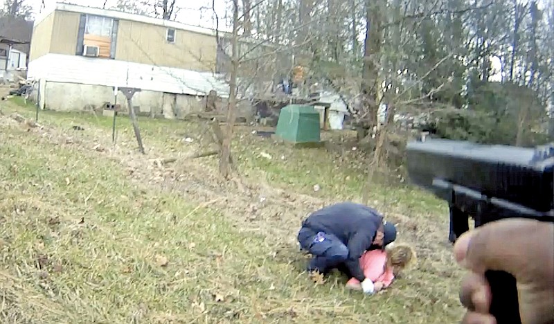 A Sevier County Sheriff's Office deputy opened fire in a mobile home park, suffered an apparent panic attack four minutes later, and was forcibly disarmed by a paramedic, body camera footage shows. (Still from video courtesy of Knoxville News Sentinel)