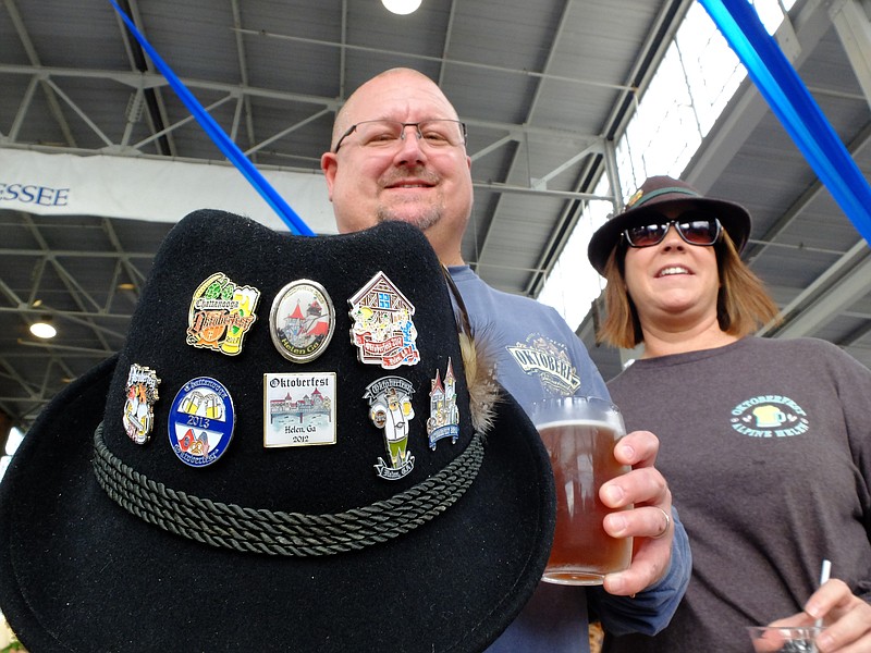 Several Chattanooga Oktoberfest pins adorn the Tyrolean hat of David Hamblen Sunday at the Chattanooga Market. "We were named Mr. and Mrs. Oktoberfest last night," Hamblen said, standing alongside his wife Lori, right.